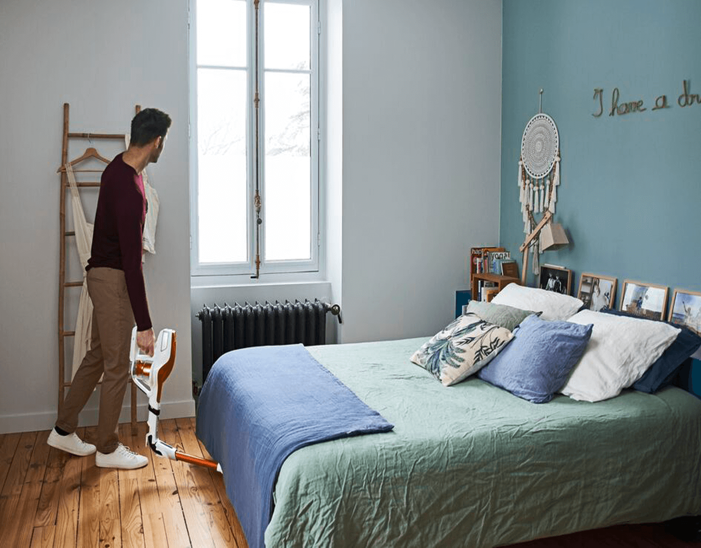 Man vacuuming under a bed