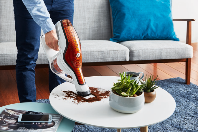 Man vacuuming on a table